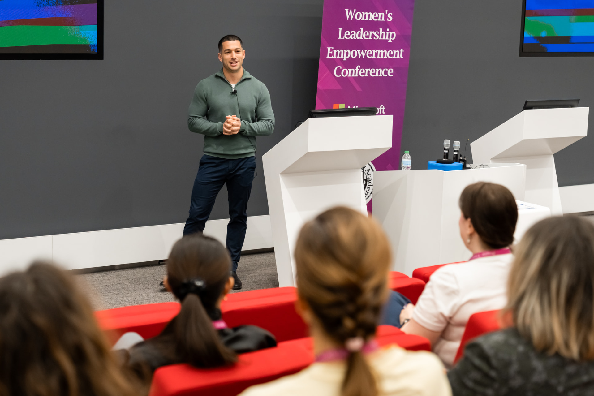 Amit Grinvald speaking to a full auditorium at the Women's Leadership Empowerment Conference