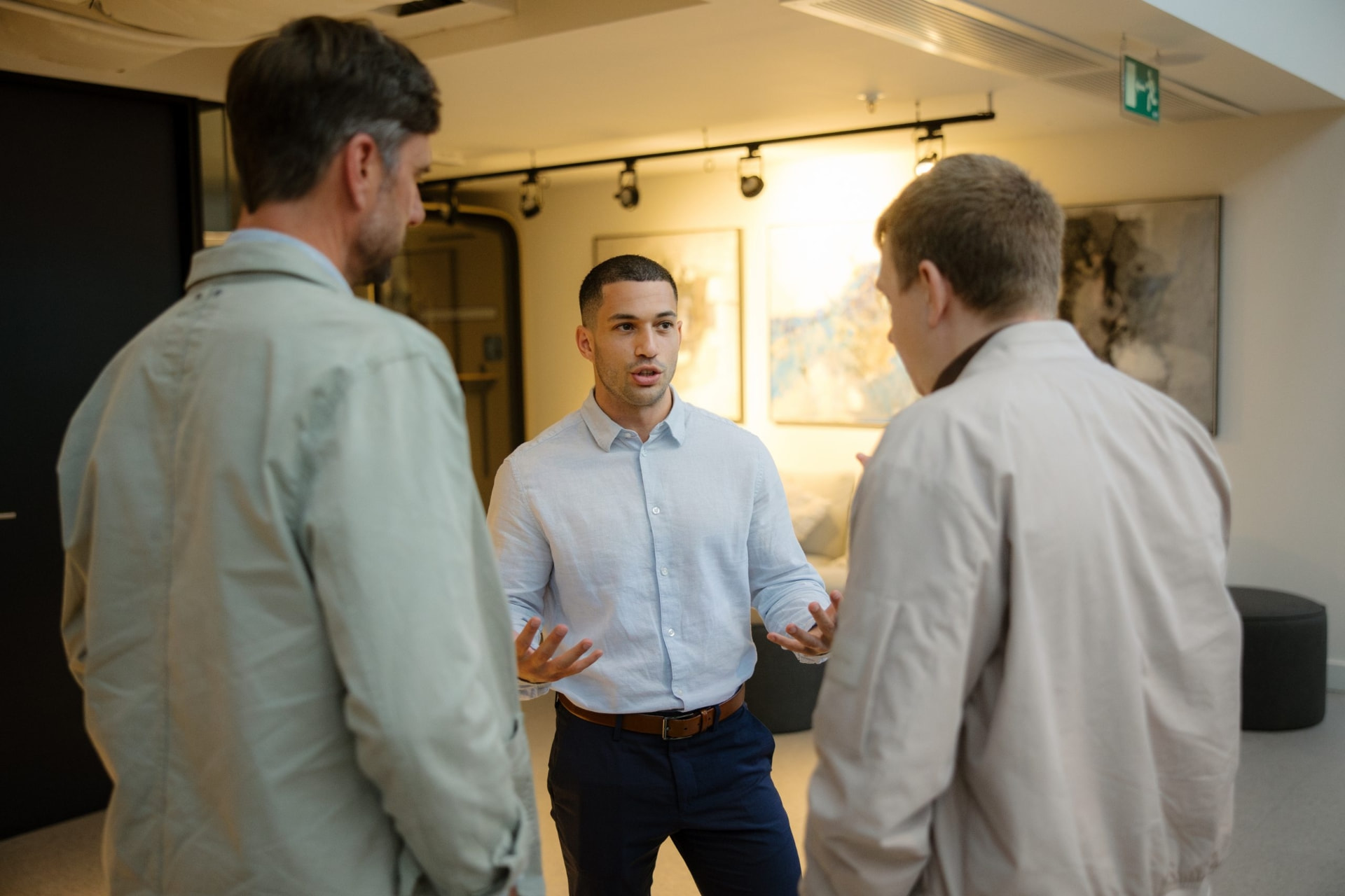 Amit Grinvald coaching two participants during a communication workshop